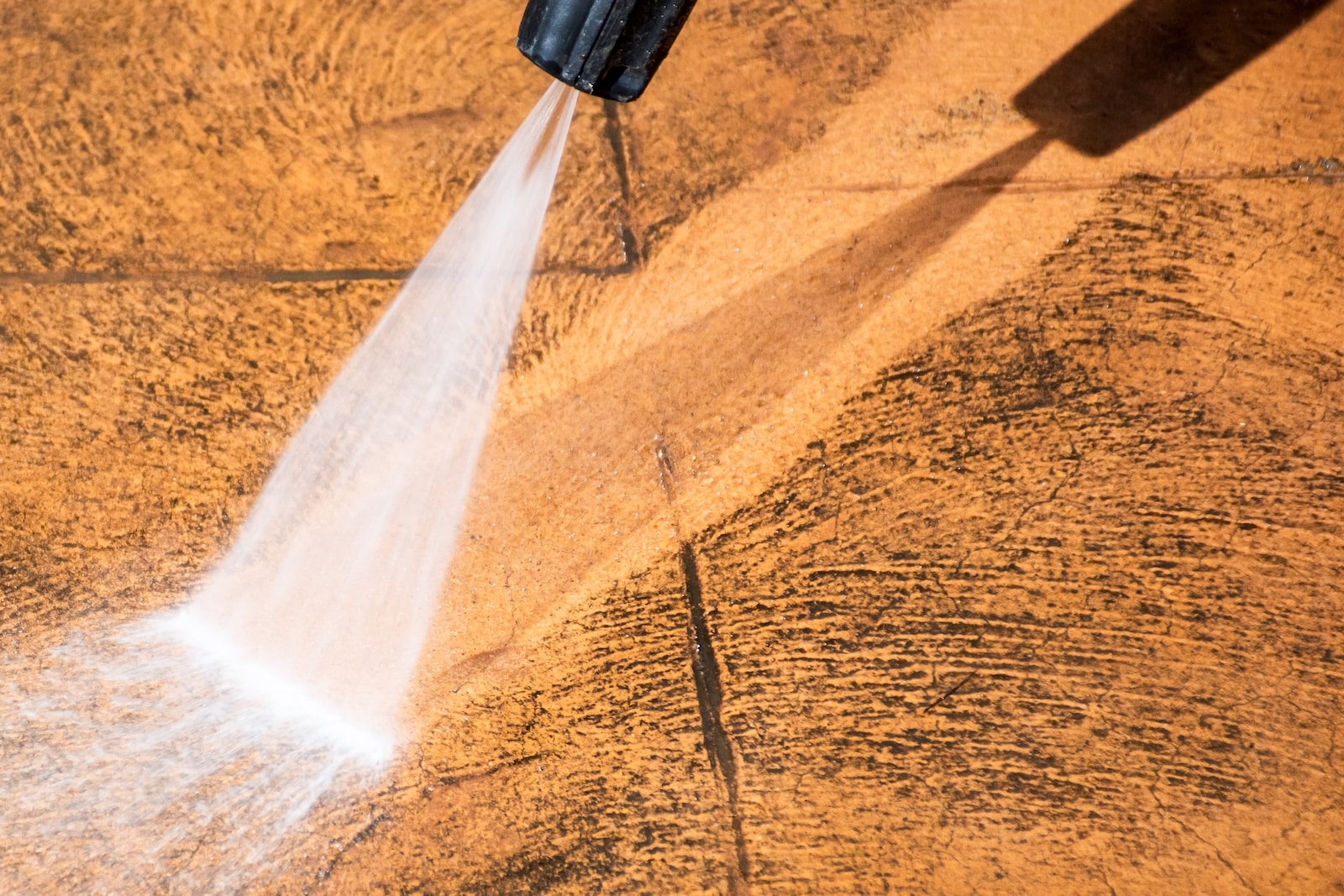 Pressure washer cleaning a concrete surface