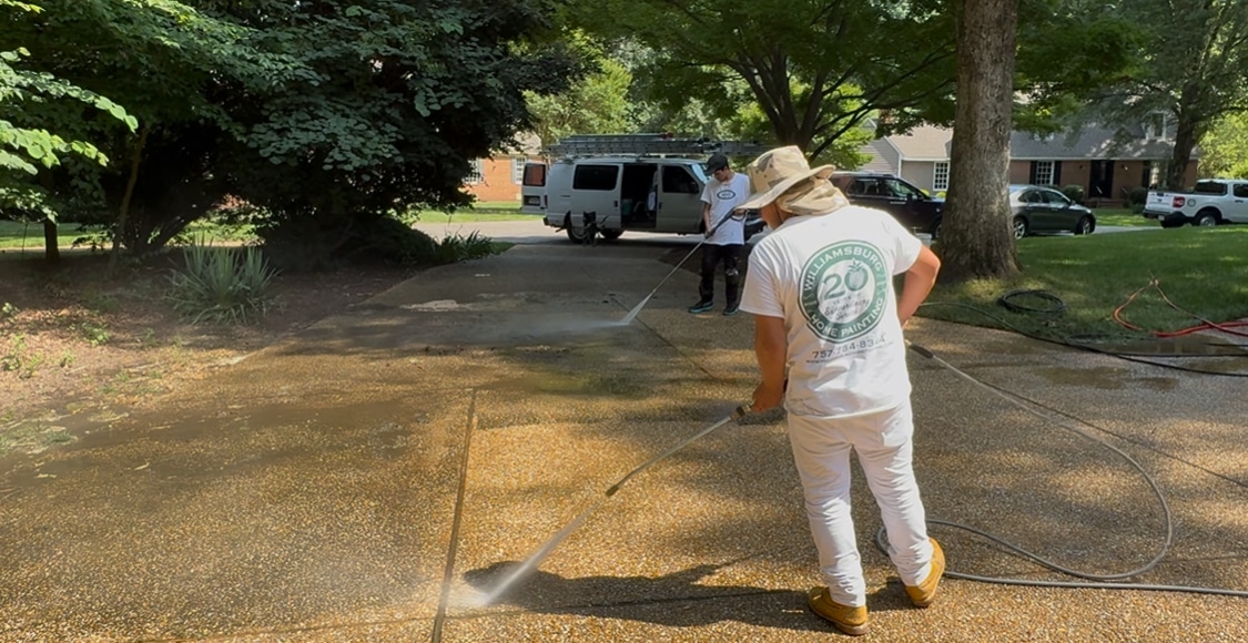 Williamsburg Home Painting crew member pressure washing a driveway