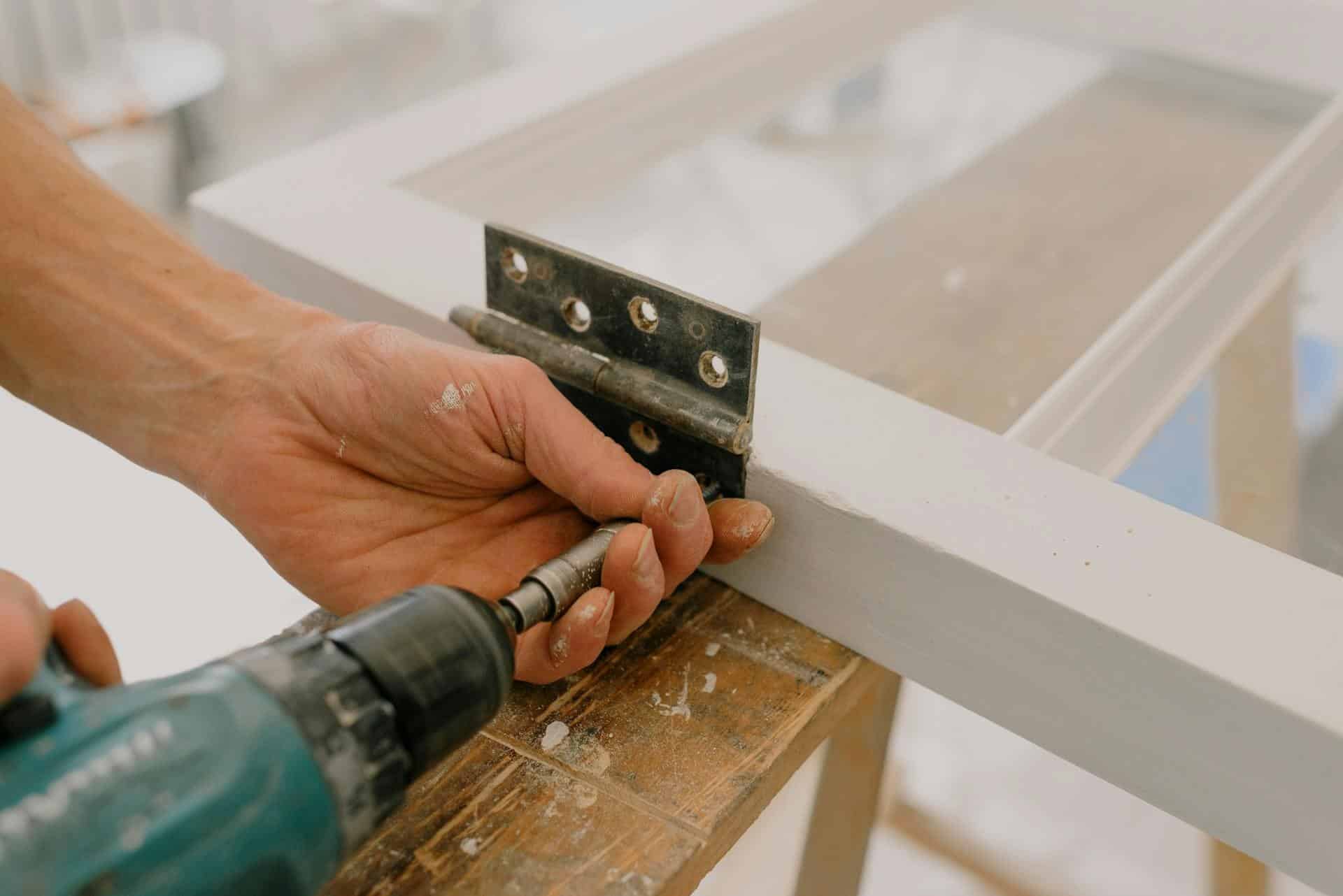 Installing a door hinge with a cordless drill