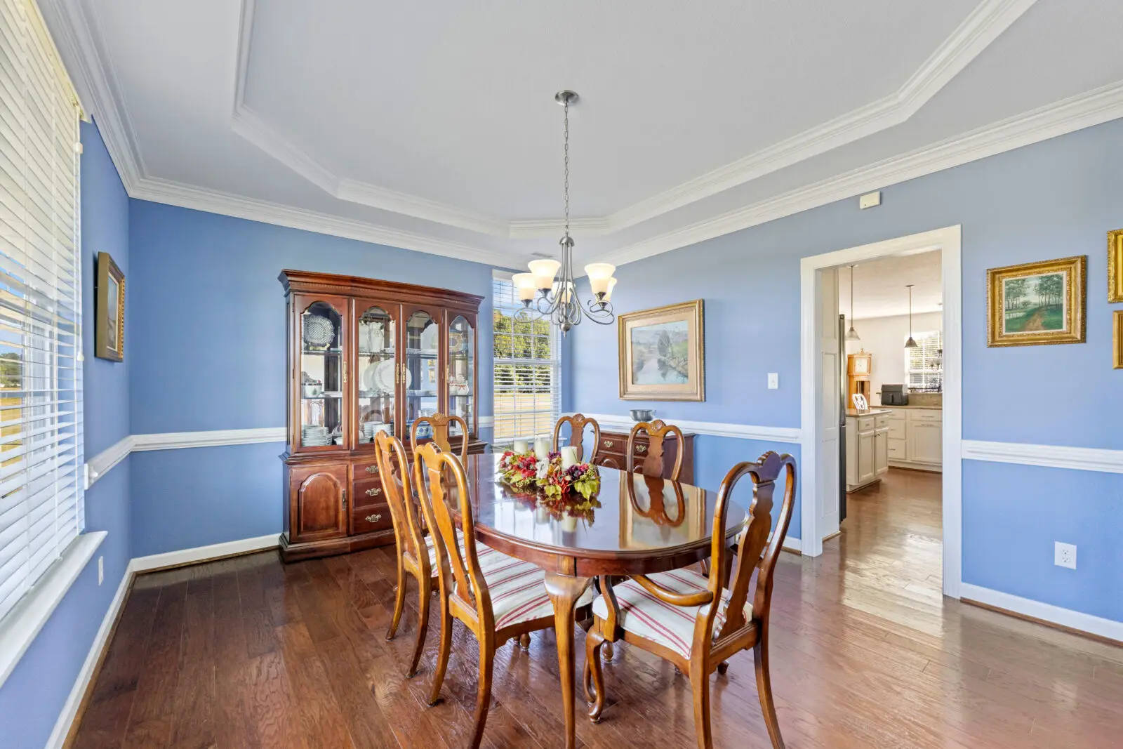 Updating a traditional home in Williamsburg VA with fresh paint on crown molding, chair rail, and dining room walls
